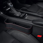 Car interior with a black cup holder tray with red stitching.